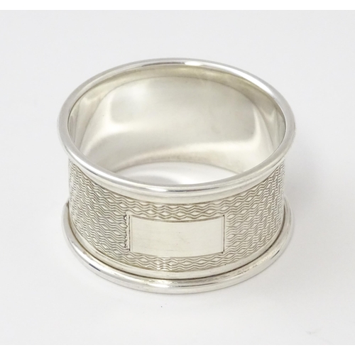 510 - A silver napkin ring with engine turned decoration. Hallmarked Sheffield 1945 maker Viner's Ltd. Cas... 