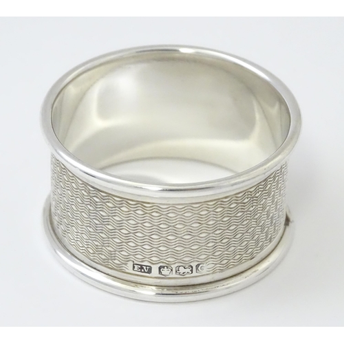 510 - A silver napkin ring with engine turned decoration. Hallmarked Sheffield 1945 maker Viner's Ltd. Cas... 