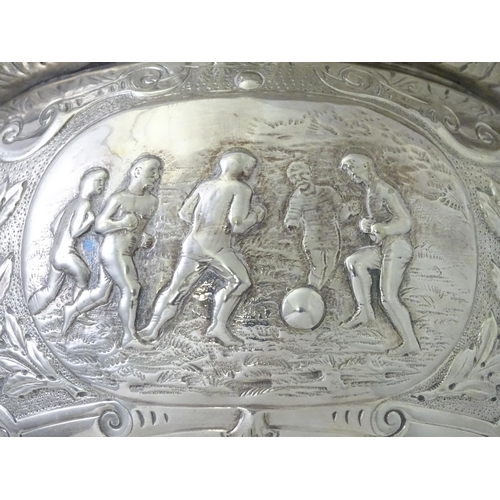 520 - A late 19th / early 20thC silver plate football trophy cup with twin handles and footballer detail. ... 