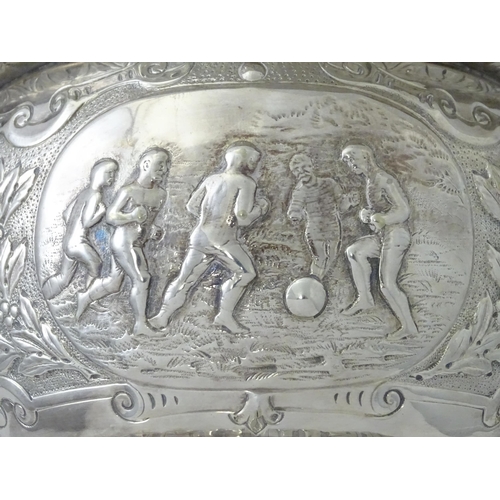 520 - A late 19th / early 20thC silver plate football trophy cup with twin handles and footballer detail. ... 