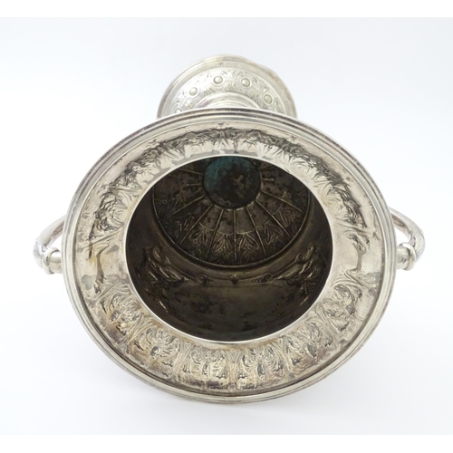 520 - A late 19th / early 20thC silver plate football trophy cup with twin handles and footballer detail. ... 