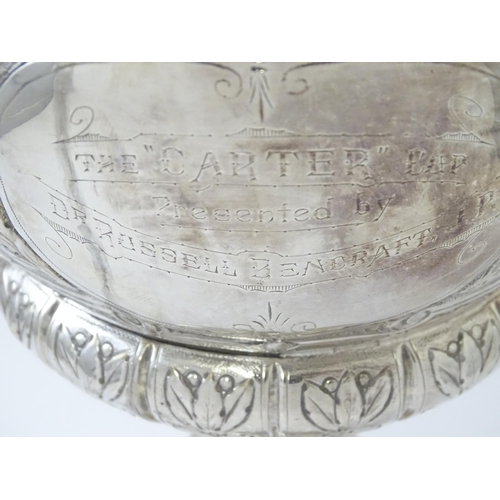 520 - A late 19th / early 20thC silver plate football trophy cup with twin handles and footballer detail. ... 