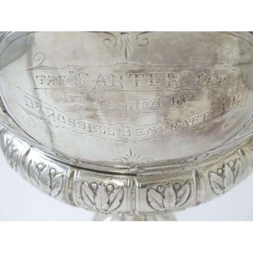 520 - A late 19th / early 20thC silver plate football trophy cup with twin handles and footballer detail. ... 