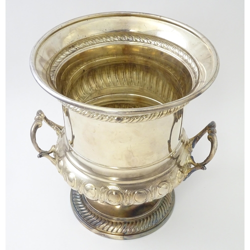 521 - A silver plate wine cooler of twin handled campana urn form. Approx. 10