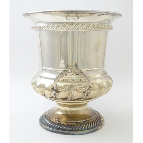 521 - A silver plate wine cooler of twin handled campana urn form. Approx. 10