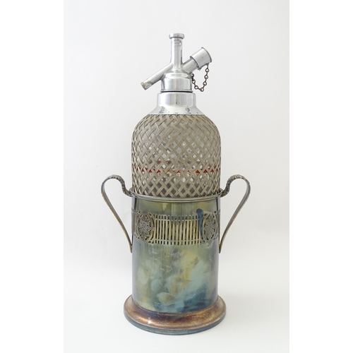 522 - An early 20thC soda siphon with silver plate stand. Approx. 15