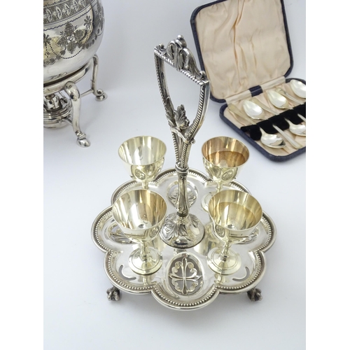 527 - A quantity of silver plated wares to include egg cruet, kettle on stand, spoons, bottle coaster etc.... 