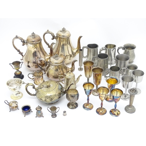 528 - A quantity of assorted silver plate, pewter and base metal wares to include goblets, tankards, cruet... 