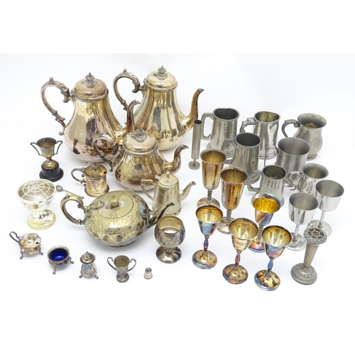 528 - A quantity of assorted silver plate, pewter and base metal wares to include goblets, tankards, cruet... 