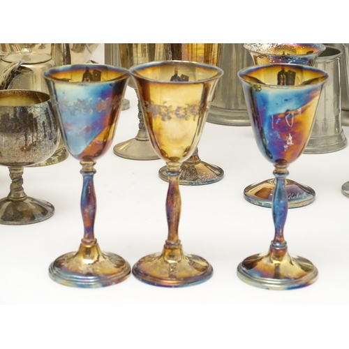 528 - A quantity of assorted silver plate, pewter and base metal wares to include goblets, tankards, cruet... 