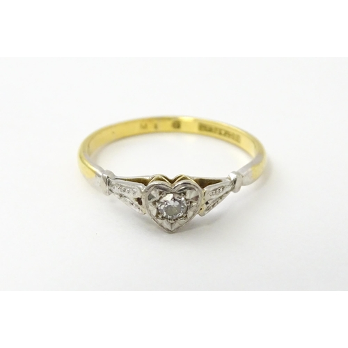 535 - An 18ct gold ring set with a diamond in a heart setting. Ring size approx. N