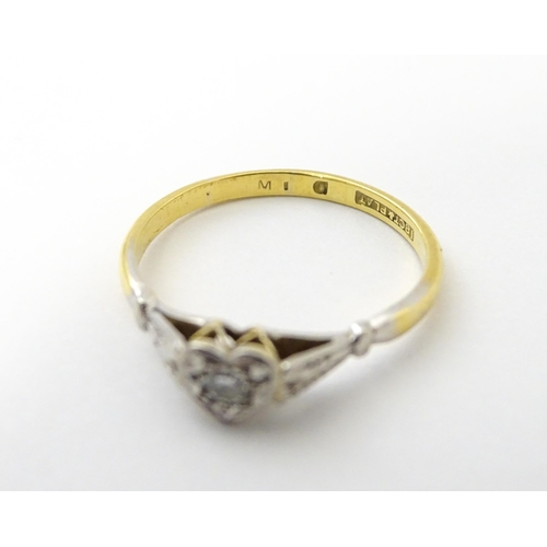 535 - An 18ct gold ring set with a diamond in a heart setting. Ring size approx. N