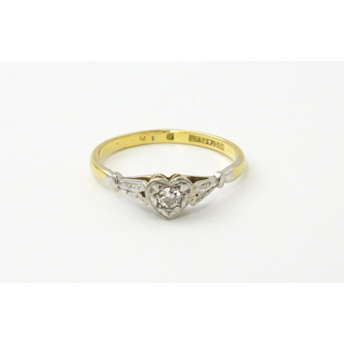 535 - An 18ct gold ring set with a diamond in a heart setting. Ring size approx. N