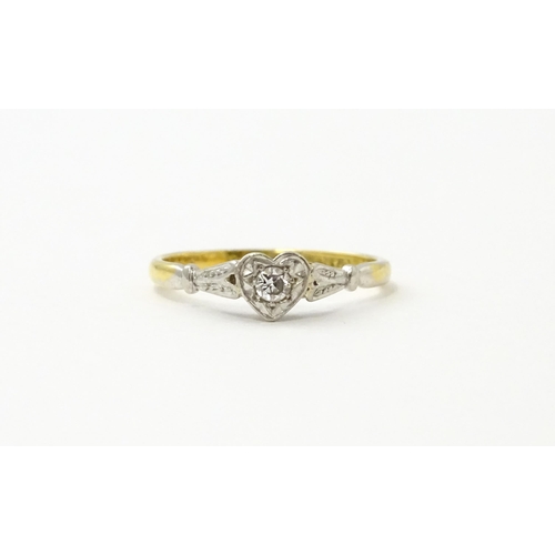 535 - An 18ct gold ring set with a diamond in a heart setting. Ring size approx. N