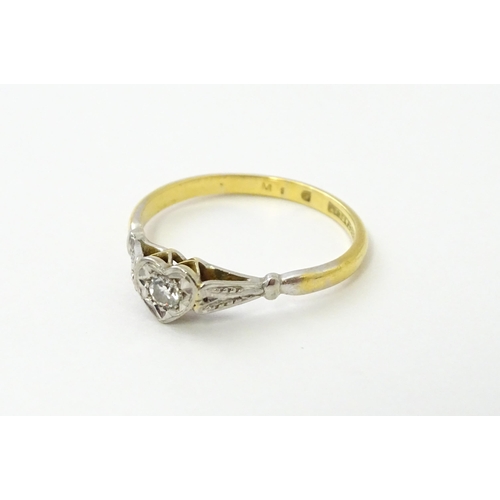 535 - An 18ct gold ring set with a diamond in a heart setting. Ring size approx. N