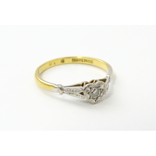 535 - An 18ct gold ring set with a diamond in a heart setting. Ring size approx. N