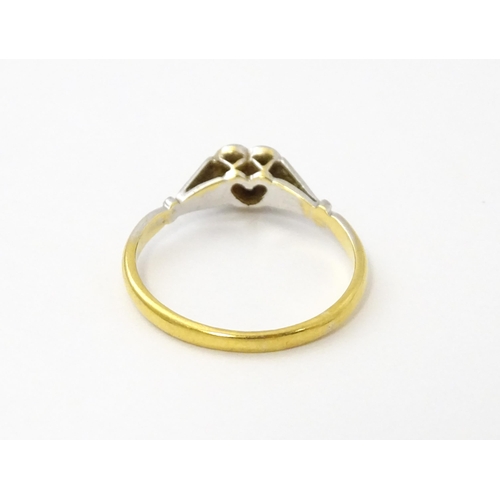 535 - An 18ct gold ring set with a diamond in a heart setting. Ring size approx. N