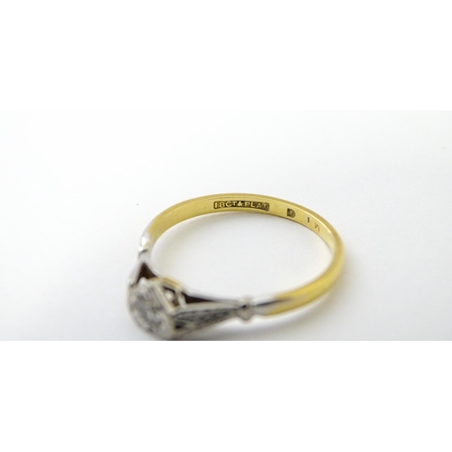 535 - An 18ct gold ring set with a diamond in a heart setting. Ring size approx. N