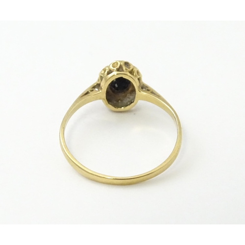 539 - A 9ct gold ring set with central sapphire bordered by diamonds. Ring size approx. M 1/2