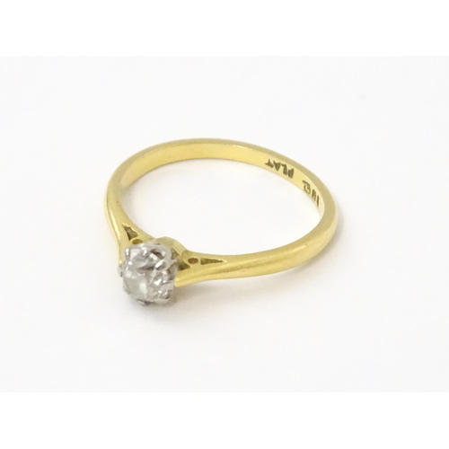 540 - An 18ct gold diamond solitaire ring set in platinum. Ring size approx. N