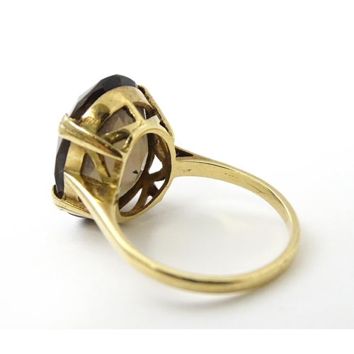 577 - A 9ct gold ring set with Smoky Quartz. Approx N 1/2