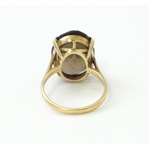 577 - A 9ct gold ring set with Smoky Quartz. Approx N 1/2