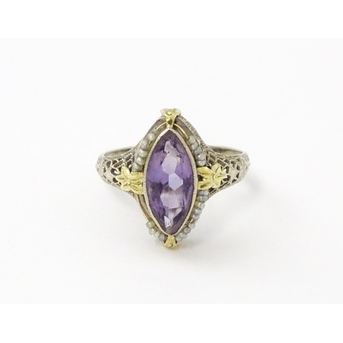 578 - A 14k gold ring set with central amethyst and seed pearls with filigree style detail. Ring size appr... 