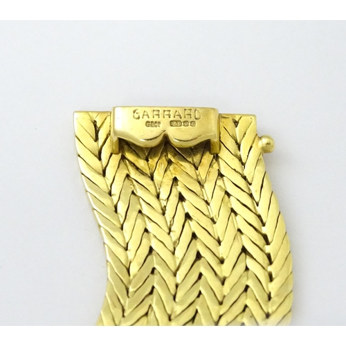 581 - An 18ct gold bracelet formed as eight rows, with textured chevron pattern, box snap clasp and safety... 