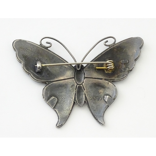 586 - A white metal brooch of butterfly form with guilloche enamel decoration, maker John Atkins & Sons. N... 