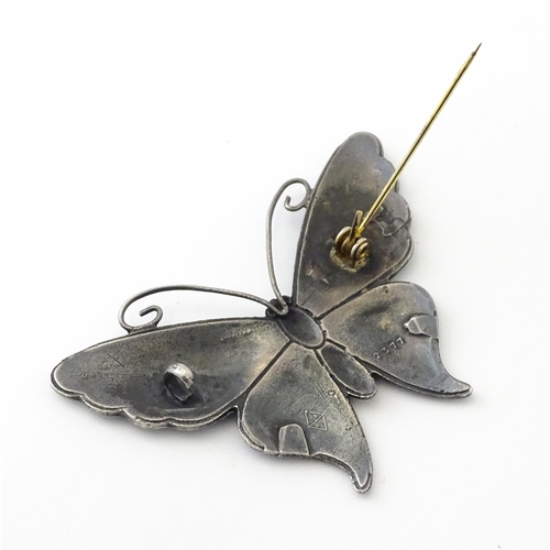 586 - A white metal brooch of butterfly form with guilloche enamel decoration, maker John Atkins & Sons. N... 