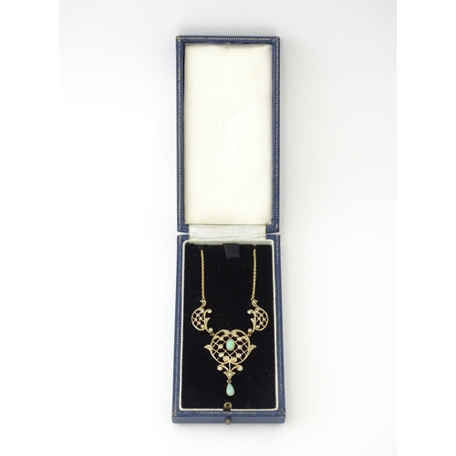 588 - A 9ct gold Art Nouveau necklace the pendant set with seed pearls and opals. On later yellow metal ch... 