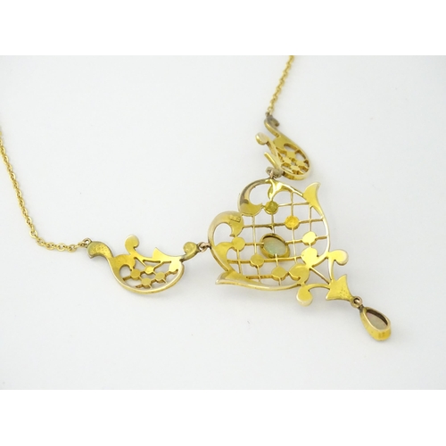 588 - A 9ct gold Art Nouveau necklace the pendant set with seed pearls and opals. On later yellow metal ch... 