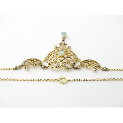 588 - A 9ct gold Art Nouveau necklace the pendant set with seed pearls and opals. On later yellow metal ch... 