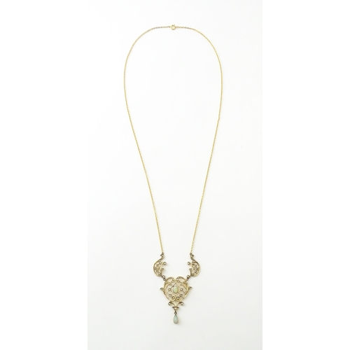 588 - A 9ct gold Art Nouveau necklace the pendant set with seed pearls and opals. On later yellow metal ch... 