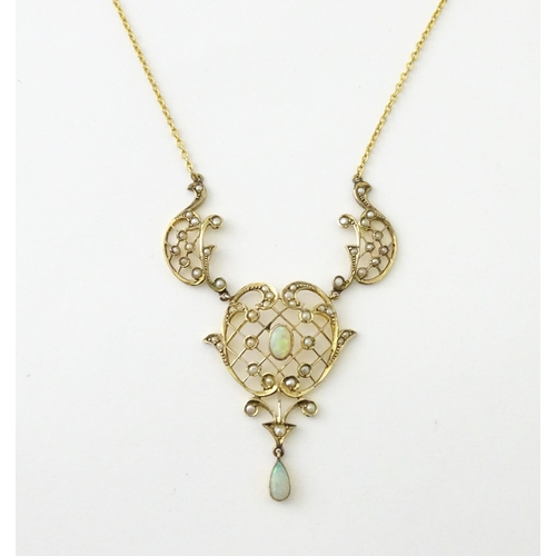 588 - A 9ct gold Art Nouveau necklace the pendant set with seed pearls and opals. On later yellow metal ch... 