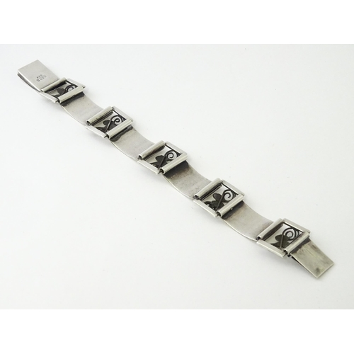 596 - A Scandinavian .830 silver bracelet with scrolling acorn style detail, and stamped W. K R for Danish... 