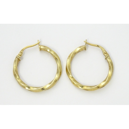 599 - A pair of 9ct gold hoop earrings. Approx. 1