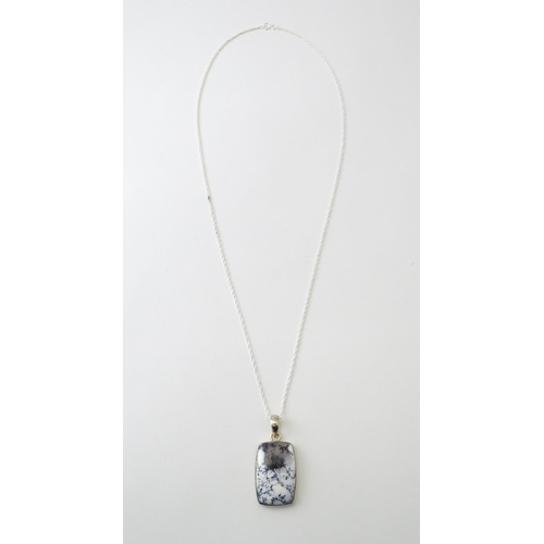 602 - A silver pendant set with dendrite agate with a silver chain. Pendant approx. 1 3/4