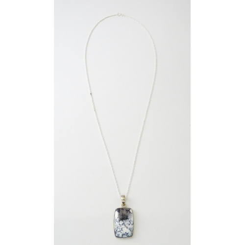 602 - A silver pendant set with dendrite agate with a silver chain. Pendant approx. 1 3/4