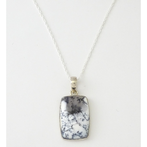 602 - A silver pendant set with dendrite agate with a silver chain. Pendant approx. 1 3/4