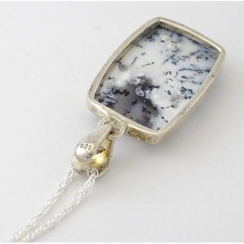 602 - A silver pendant set with dendrite agate with a silver chain. Pendant approx. 1 3/4