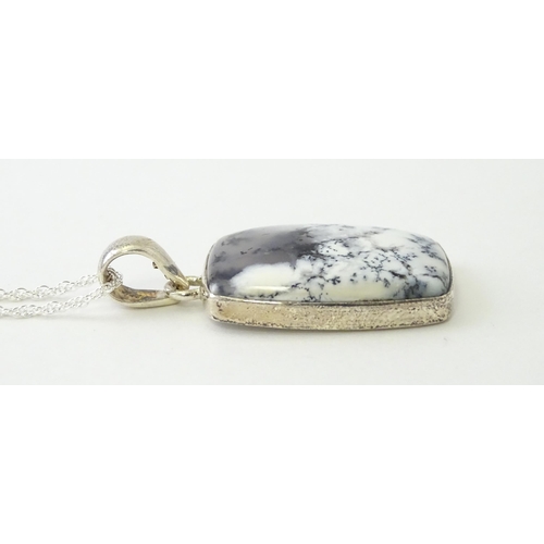 602 - A silver pendant set with dendrite agate with a silver chain. Pendant approx. 1 3/4