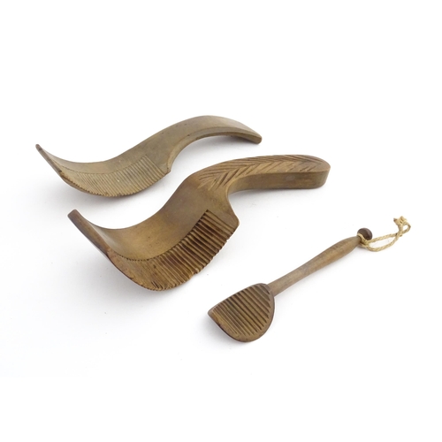 1159 - Treen : Two 19thC sycamore butter curlers having ribbed blades, one with carved foliate detail to ha... 