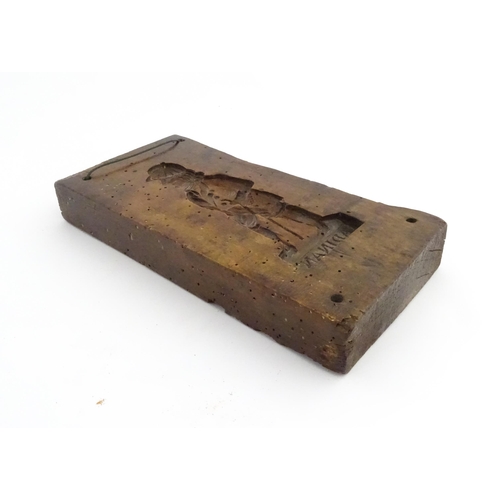 1162 - Treen : A 19thC sycamore gingerbread biscuit / cookie mould with carved figural decoration titled Ad... 