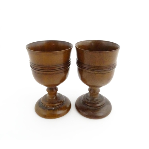 1163 - Treen : A pair of early 19thC fruitwood goblets with turned banded decoration. Approx. 4 3/4