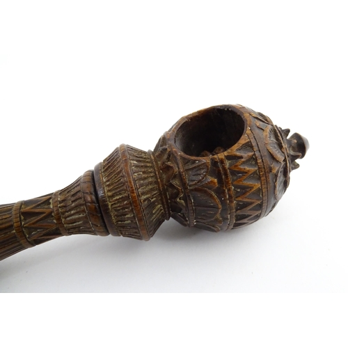 1167 - Treen : A 19thC nutcracker with chip carved decoration, with carved initials R.I.G. to reverse. Appr... 