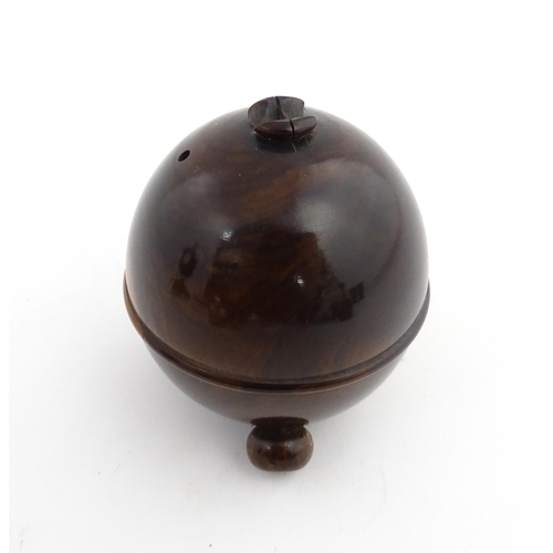 1168 - Treen : A 19thC lignum vitae string box of circular form raised on three feet. Approx. 3