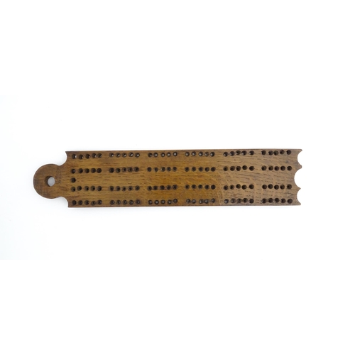 1171 - Treen : A 19thC oak cribbage board. Approx. 13 1/4