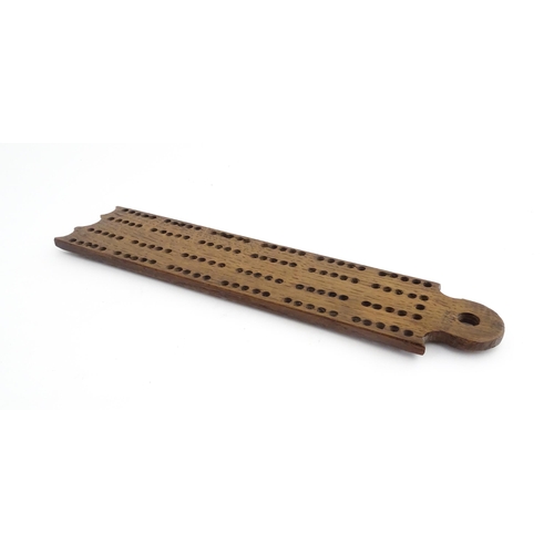 1171 - Treen : A 19thC oak cribbage board. Approx. 13 1/4