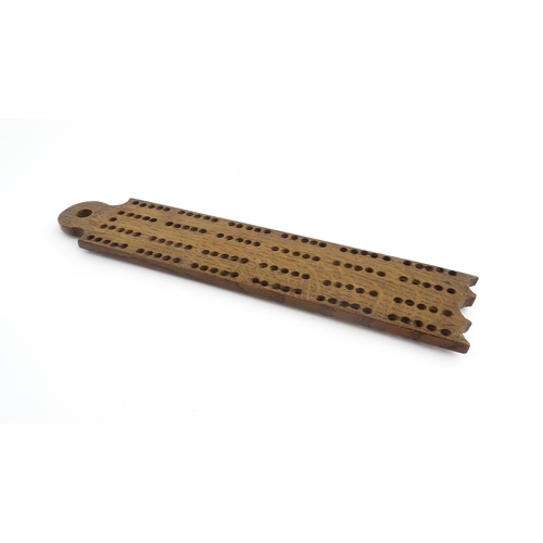 1171 - Treen : A 19thC oak cribbage board. Approx. 13 1/4